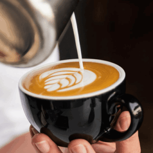 Two professional baristas working behind a coffee bar, preparing espresso drinks in a modern café.